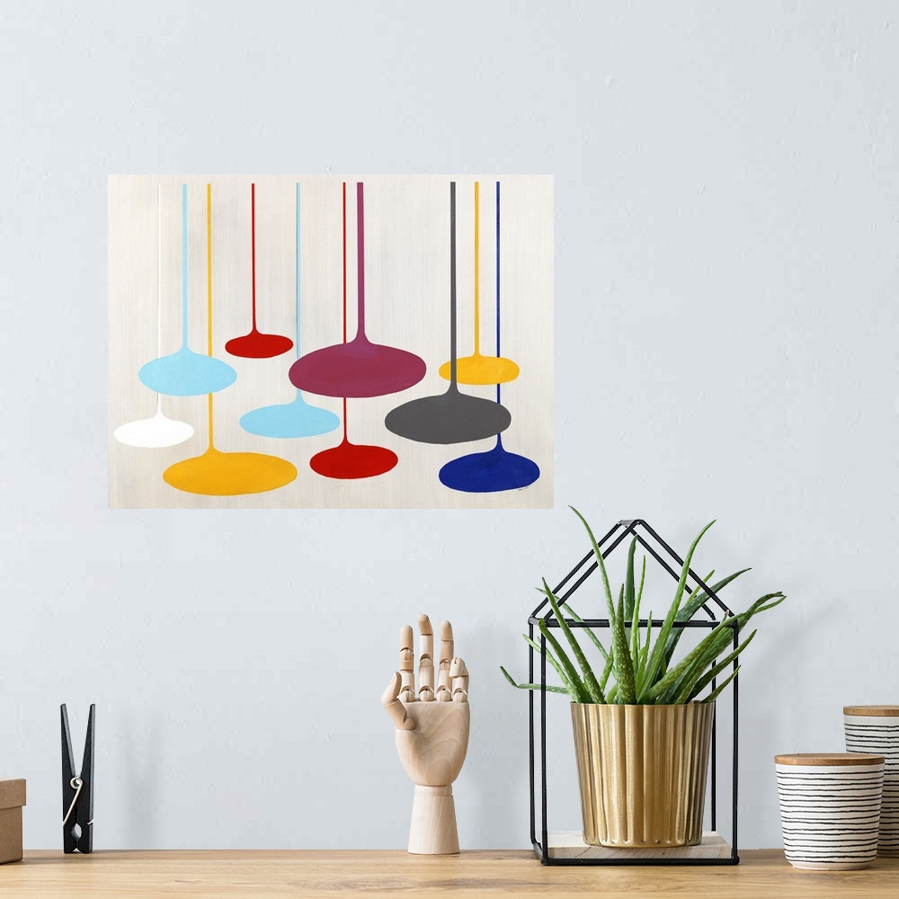 A bohemian room featuring Contemporary artwork with retro shapes in bright primary colors.