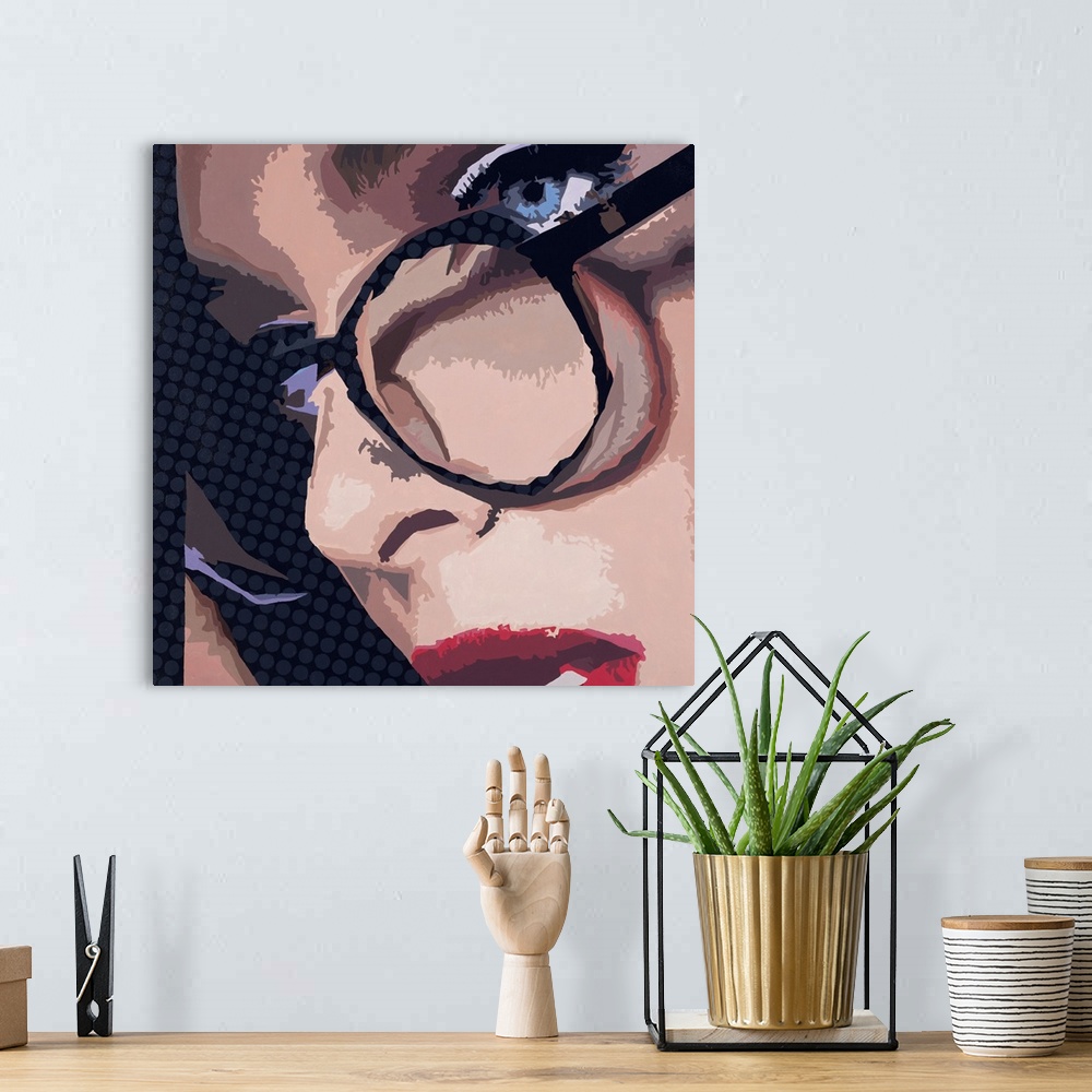 A bohemian room featuring Close-up square artwork of a woman wearing glasses on a polka dotted background.
