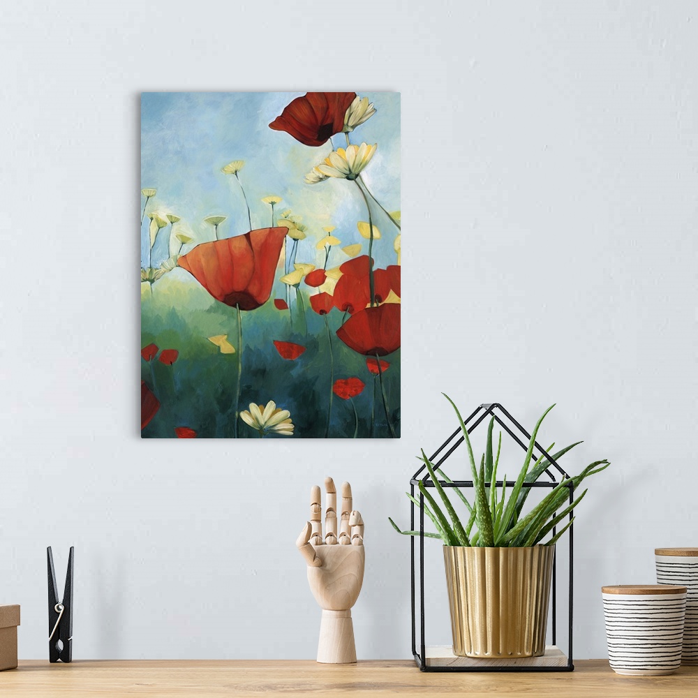 A bohemian room featuring Contemporary painting of red poppies in a green field with daisies, under a blue sky.