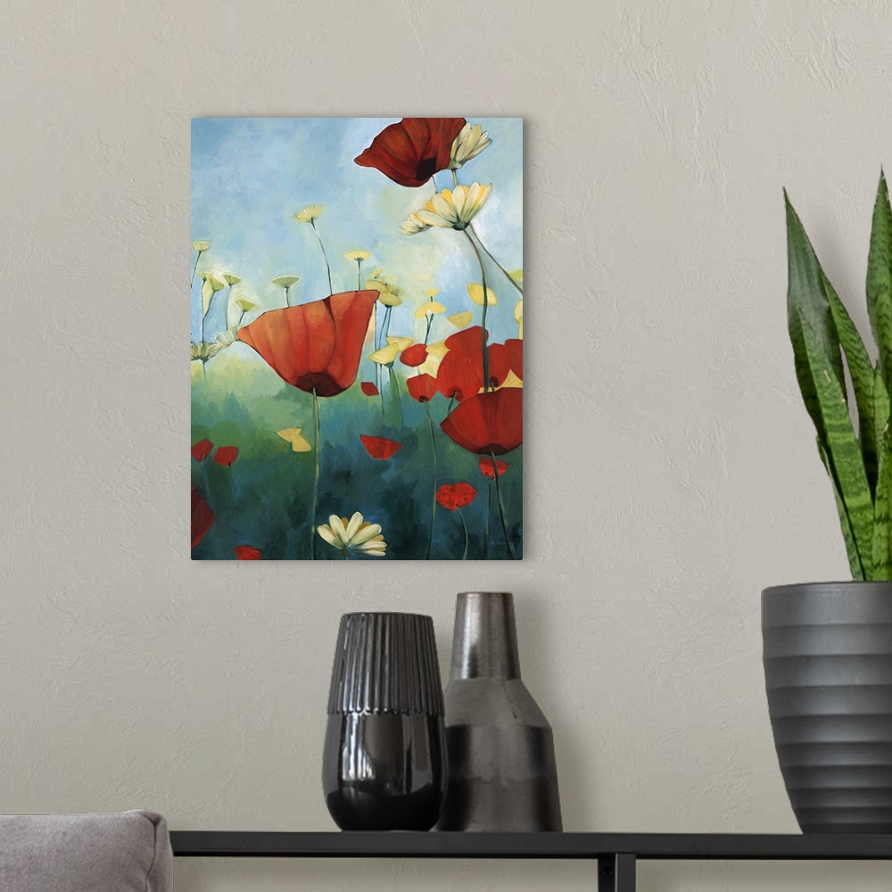 A modern room featuring Contemporary painting of red poppies in a green field with daisies, under a blue sky.