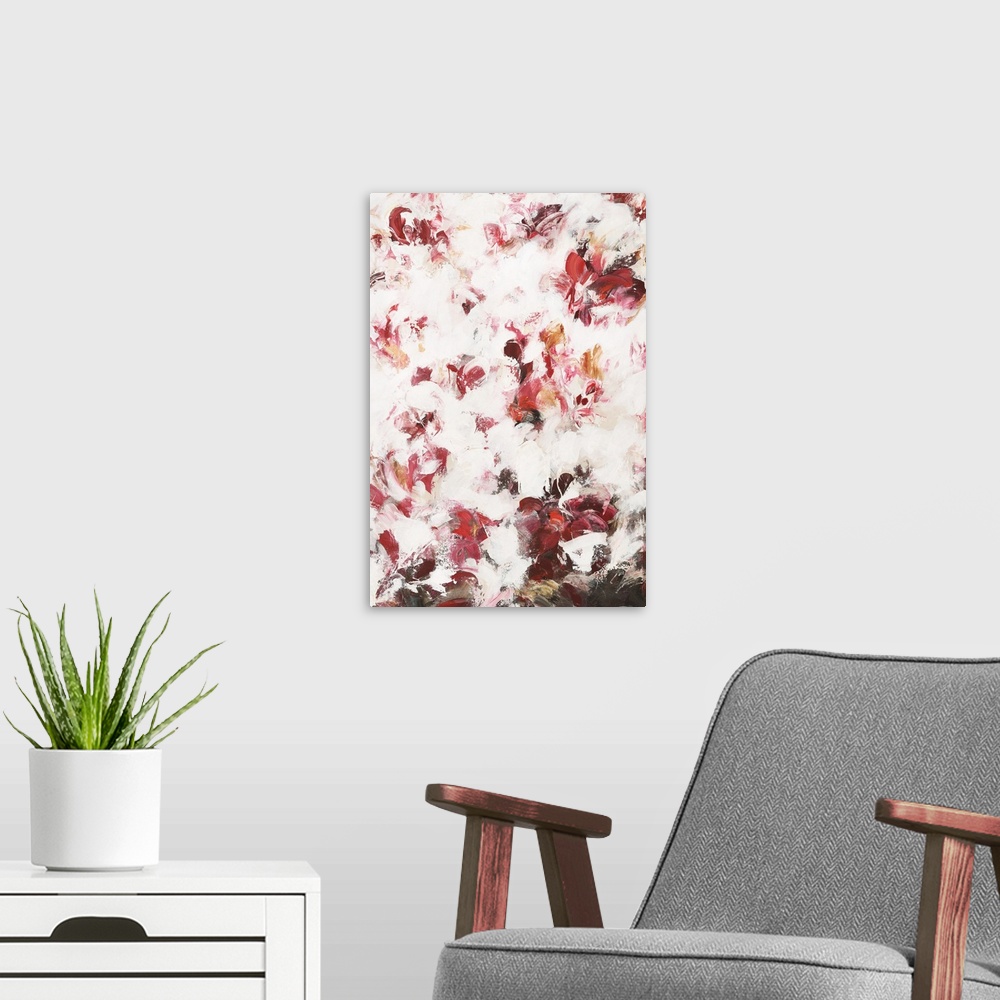 A modern room featuring Large abstract painting with warm shades of red, pink, and orange with white on top and brown a t...