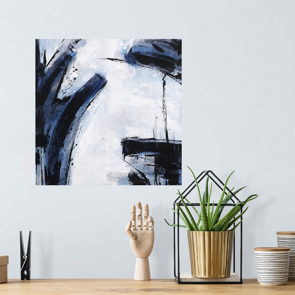 A bohemian room featuring Abstract painting using dark blue and black colors against a pale blue blue background.