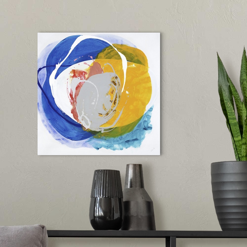 A modern room featuring A bright abstract painting in a circular shape in colors of blue and yellow.
