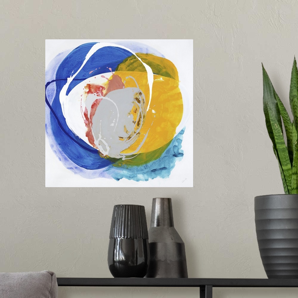 A modern room featuring A bright abstract painting in a circular shape in colors of blue and yellow.
