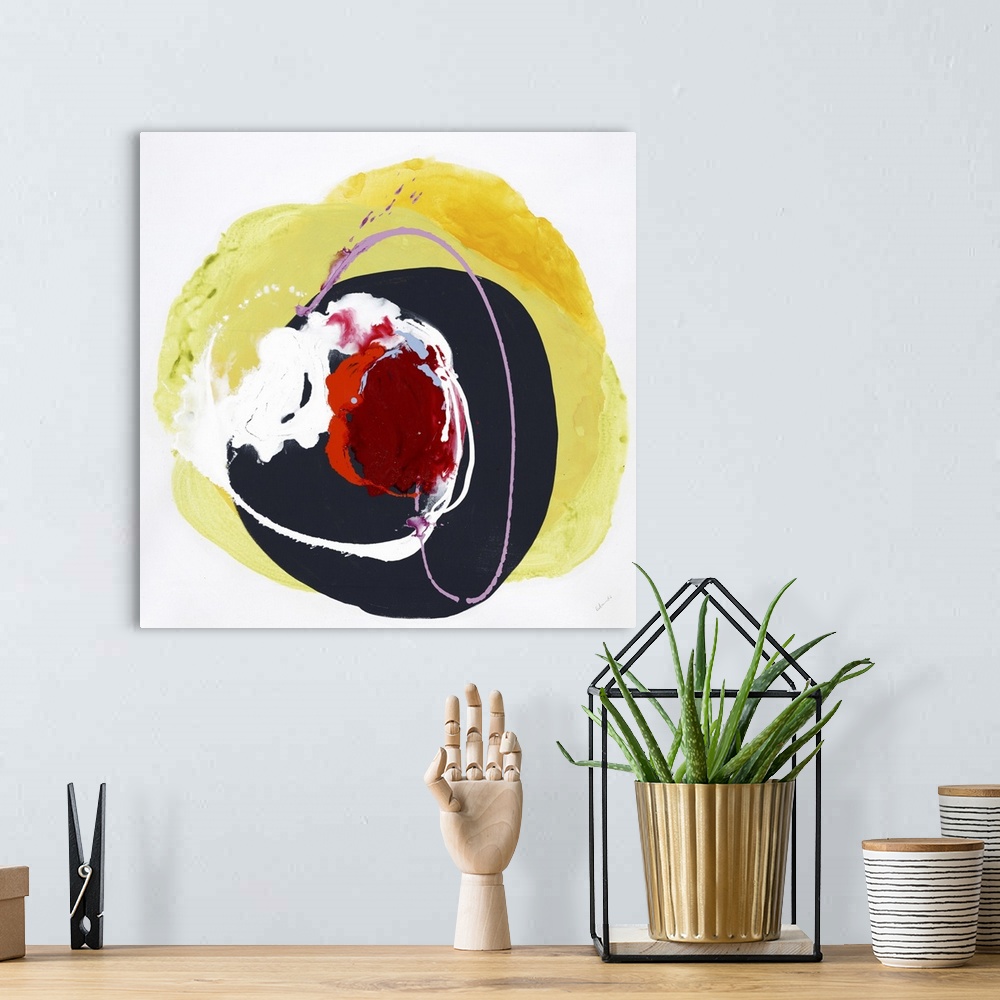 A bohemian room featuring A vibrant abstract painting in a circular shape in colors of red and yellow.