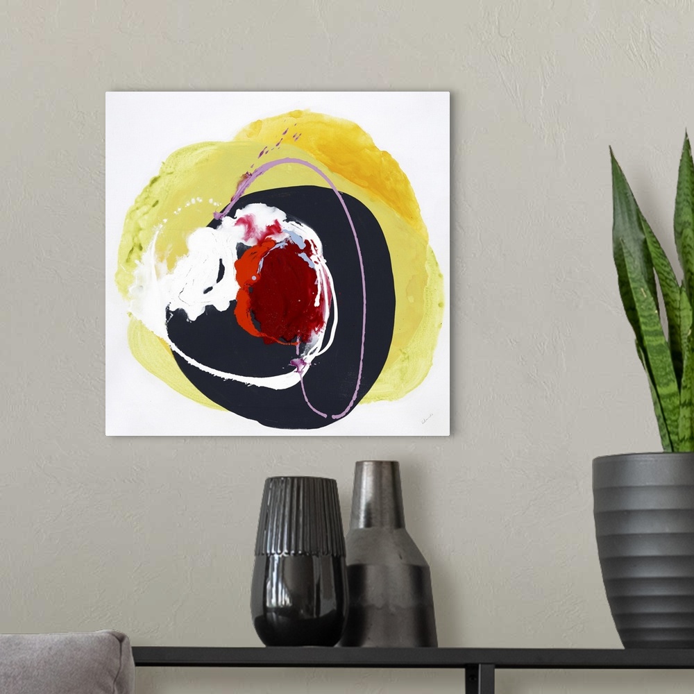 A modern room featuring A vibrant abstract painting in a circular shape in colors of red and yellow.