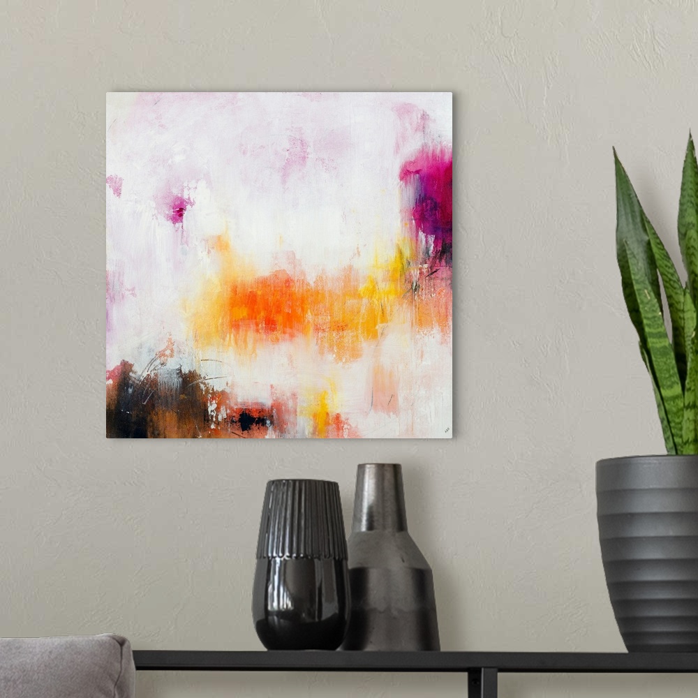 A modern room featuring Large abstract painting in warm pink, purple, yellow, and orange hues on a square canvas.