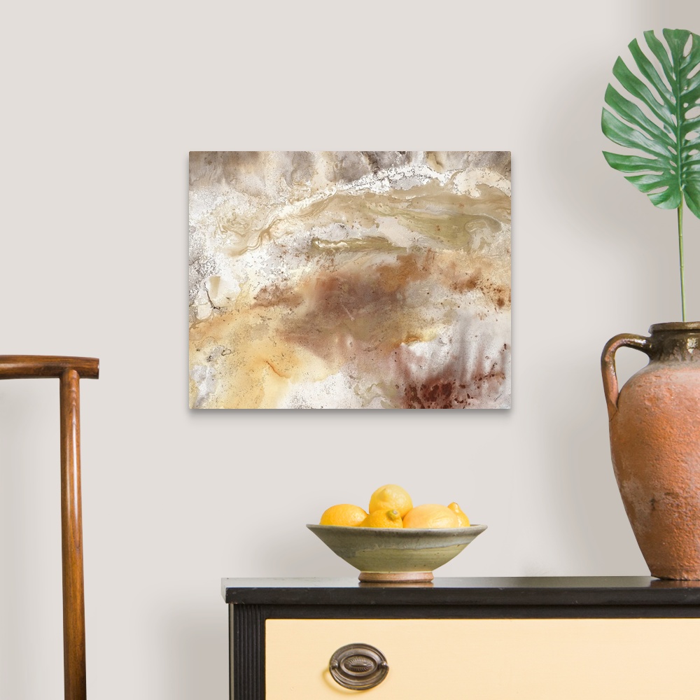 A traditional room featuring An abstract painting of natural earth colors of brown and gold.