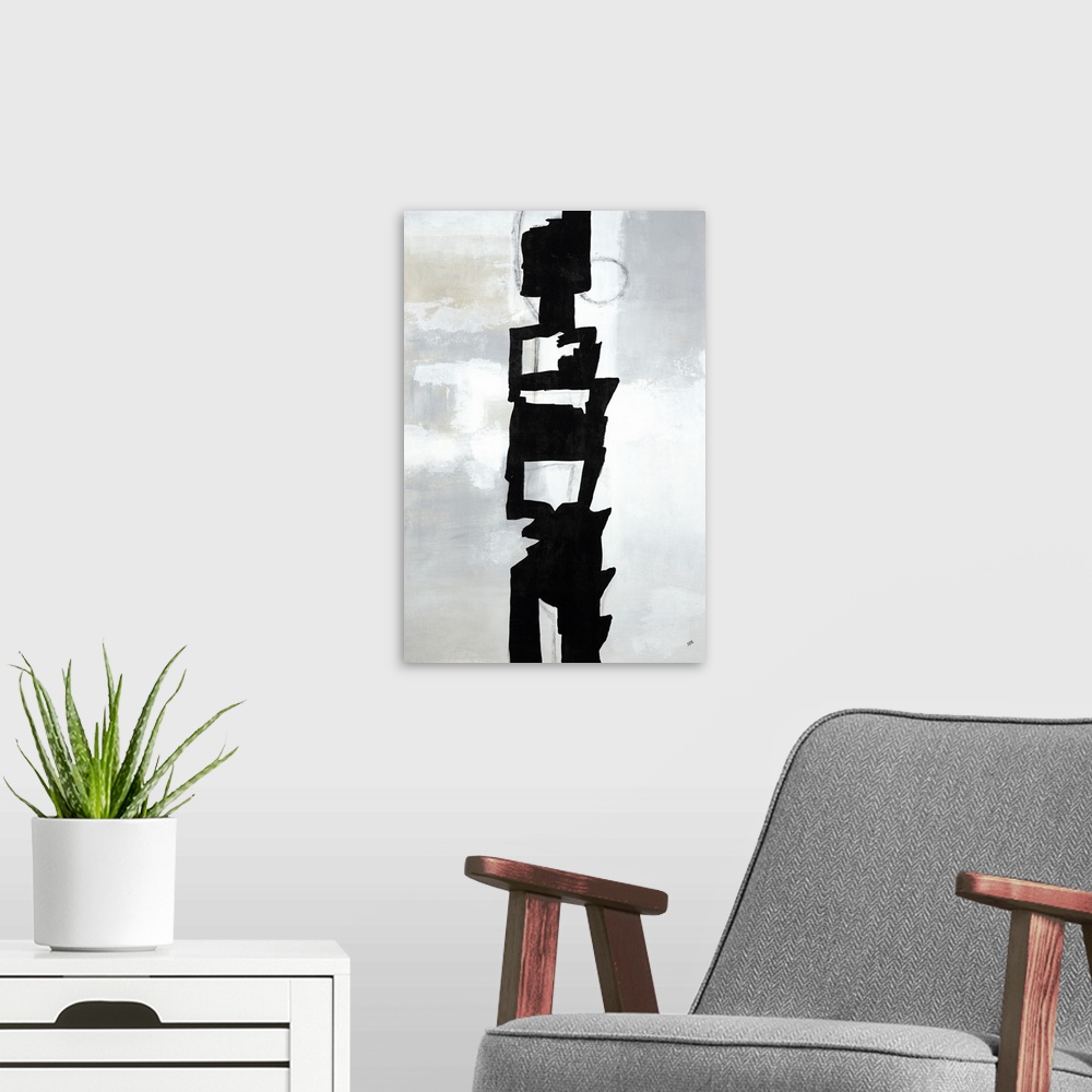 A modern room featuring Large vertical painting of a black abstract shape in the center of a gray background.