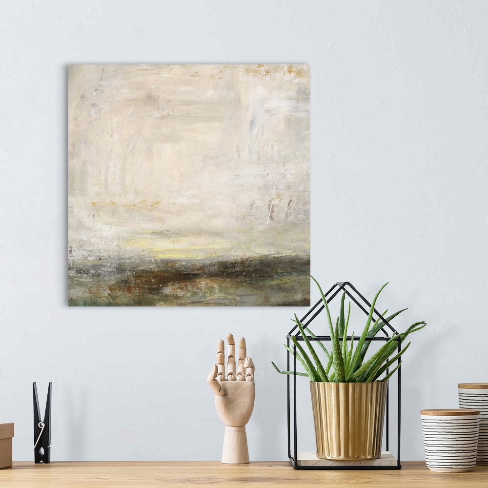 A bohemian room featuring Abstract painting of a bare landscape beneath a light, cloudy sky as the sun is setting on the ho...