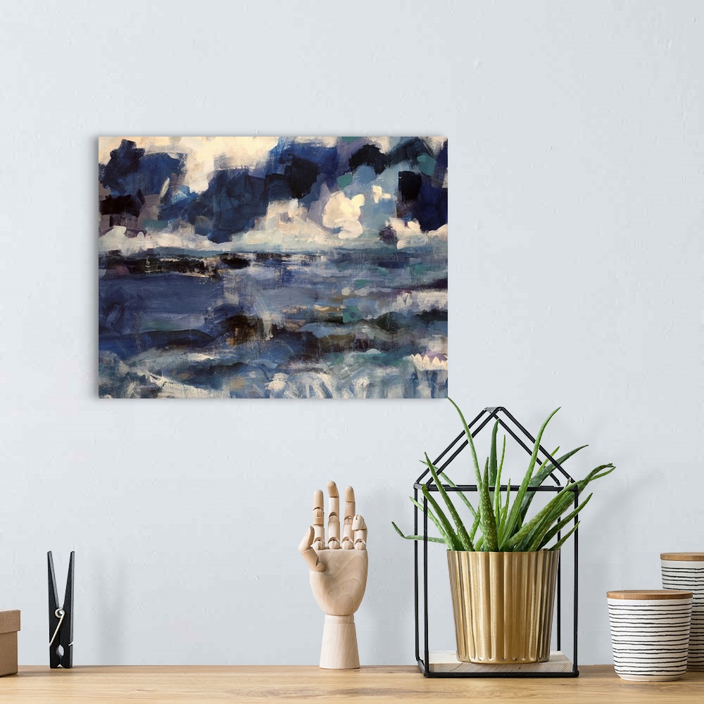 A bohemian room featuring Abstract artwork that uses various shades of blue that depict an ocean below with a cloudy sky ab...