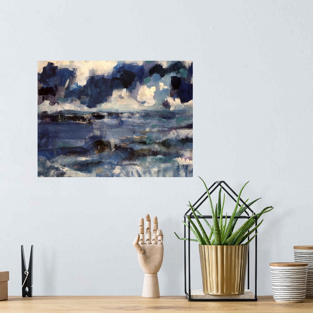 A bohemian room featuring Abstract artwork that uses various shades of blue that depict an ocean below with a cloudy sky ab...