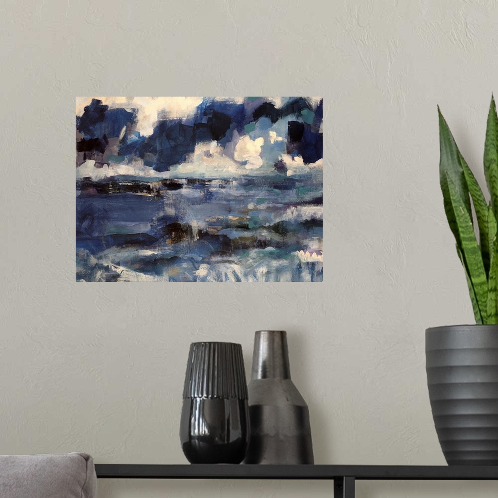 A modern room featuring Abstract artwork that uses various shades of blue that depict an ocean below with a cloudy sky ab...