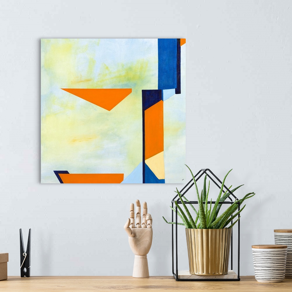 A bohemian room featuring Square abstract artwork with a light blue and green background and vibrant blue and orange shapes...