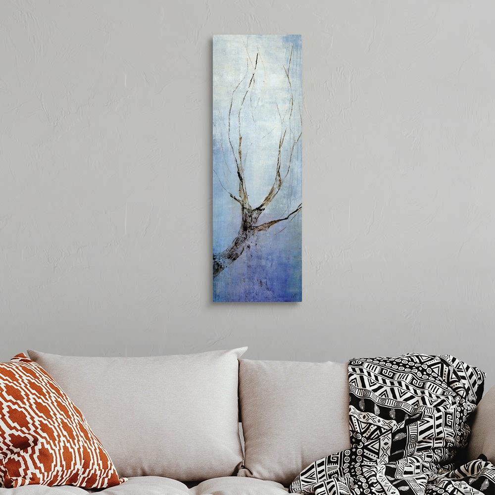 A bohemian room featuring Contemporary artwork with a single bare tree branch going vertically and a blue background.