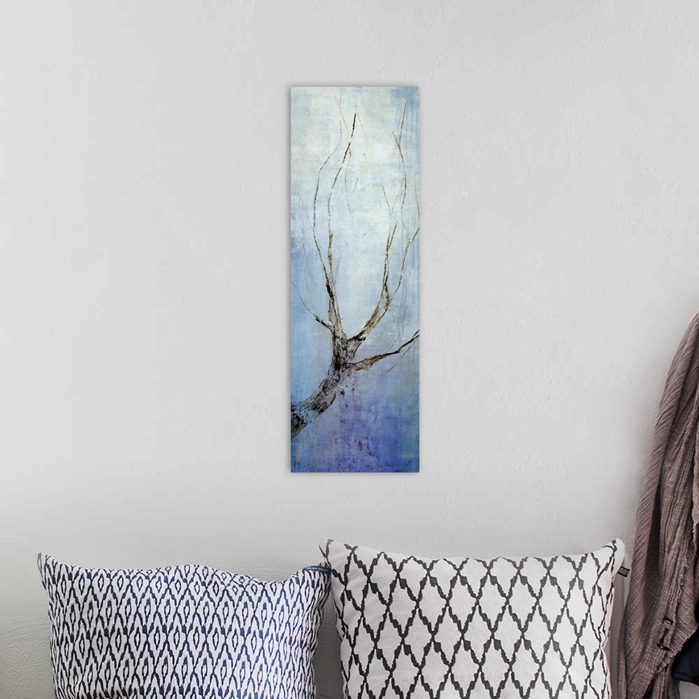 A bohemian room featuring Contemporary artwork with a single bare tree branch going vertically and a blue background.