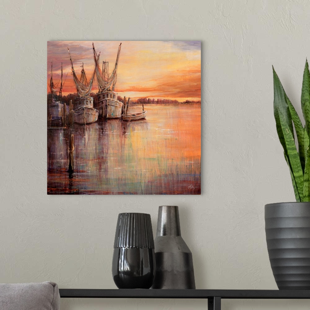 A modern room featuring Painting of old sailboats docked at sunset under a colorful cloudy sky.