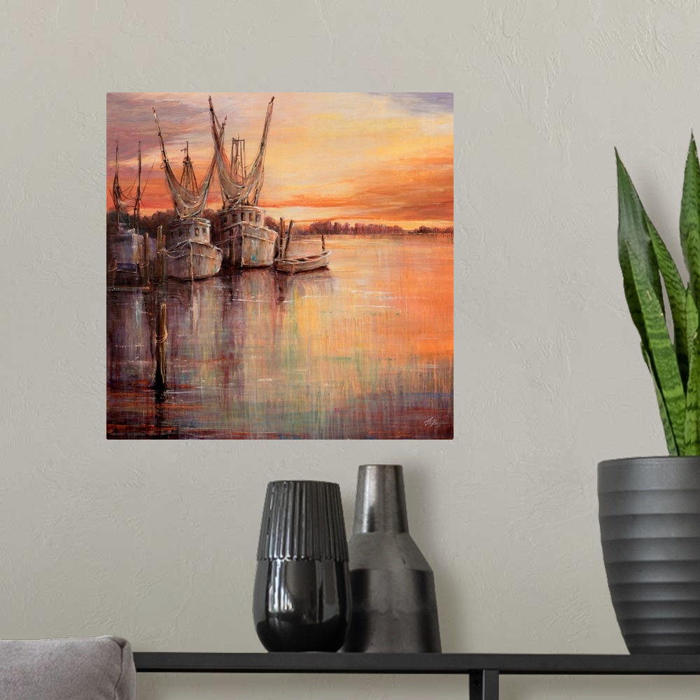 A modern room featuring Painting of old sailboats docked at sunset under a colorful cloudy sky.