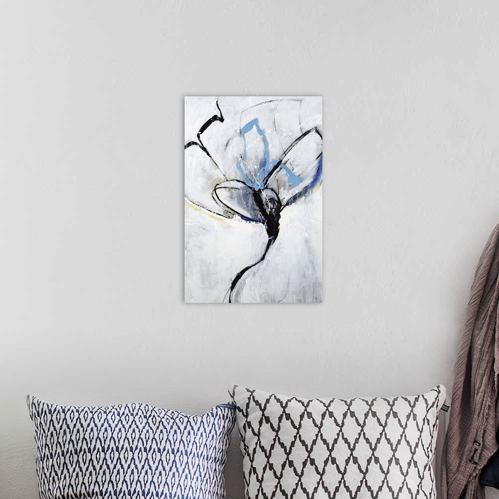 A bohemian room featuring An abstract floral painting with colors of blue and yellow along with the light gray background.