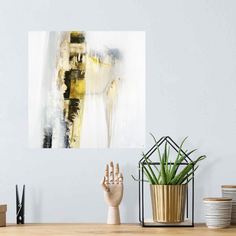 A bohemian room featuring Square abstract painting with a yellow and black vertical line going down the canvas with a faint...
