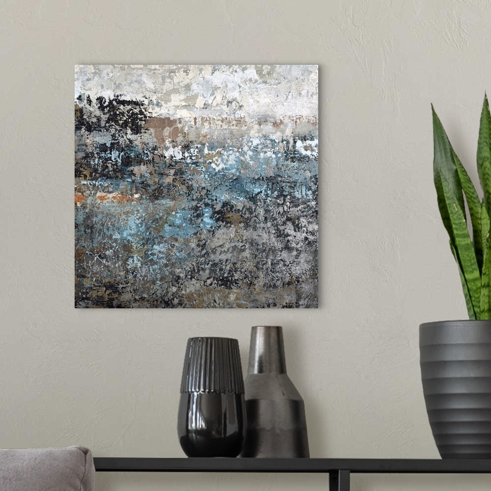 A modern room featuring Abstract painting using textured looking blue and gray tones to form what almost appears as a lan...