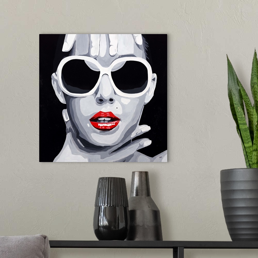 A modern room featuring Contemporary pop artwork of a woman's face with large sunglasses, framed by her hands.