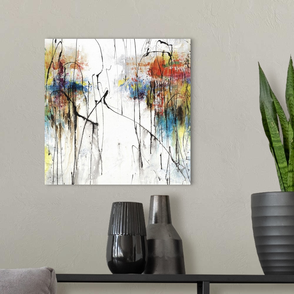 A modern room featuring Square abstract art with clusters of color on the two sides on a white and gray background with t...