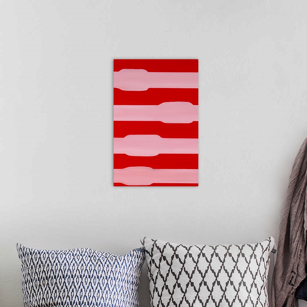 A bohemian room featuring Red and pink asymmetric abstract painting.