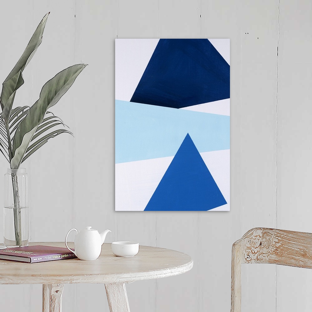 A farmhouse room featuring Geometric abstract painting that has a white background with three large triangular shapes stacke...