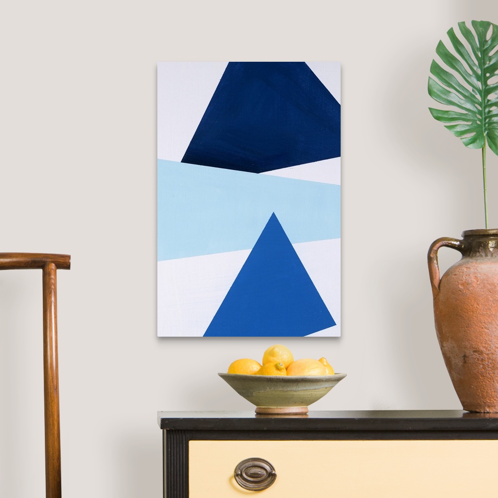 A traditional room featuring Geometric abstract painting that has a white background with three large triangular shapes stacke...