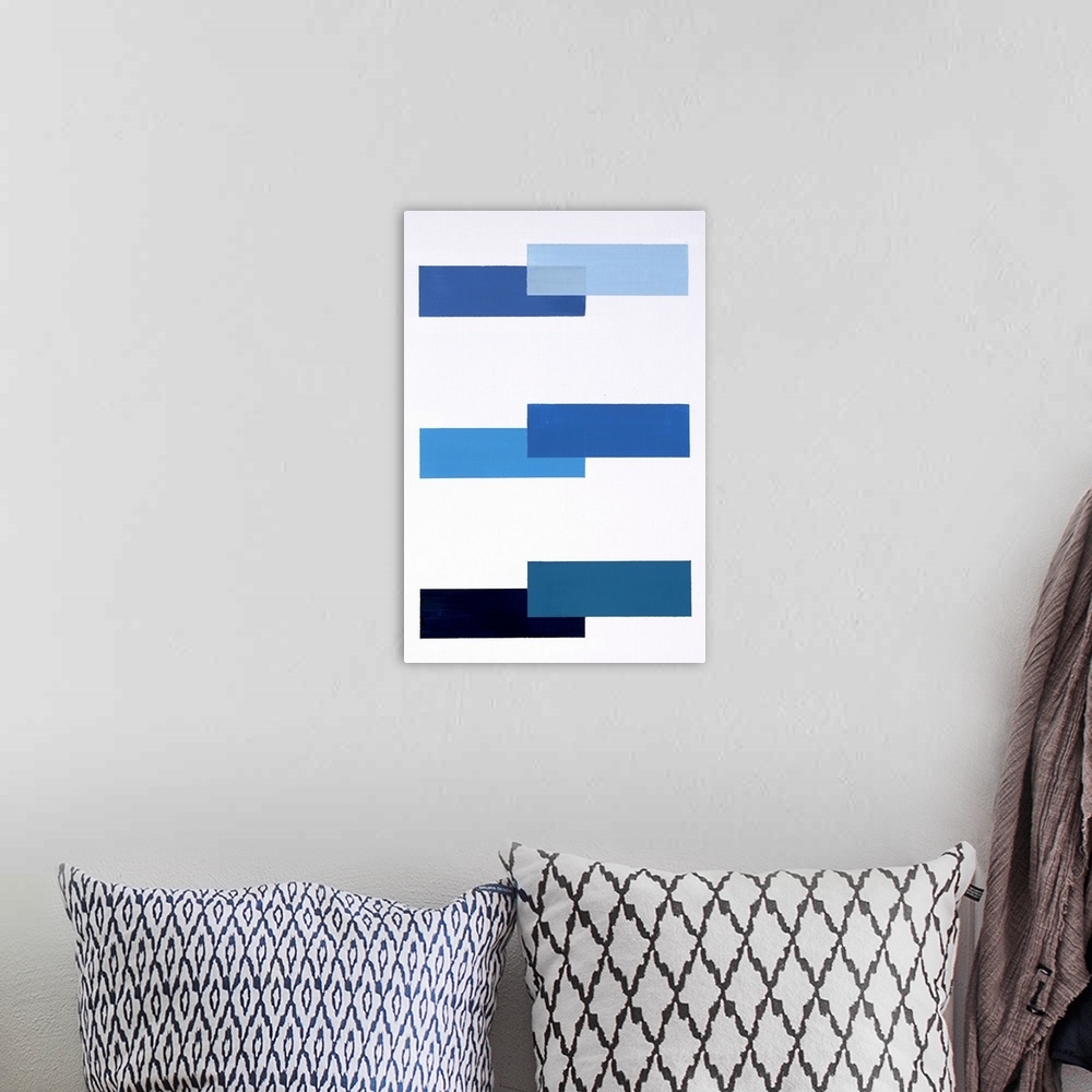 A bohemian room featuring Geometric abstract painting with a solid white background and various shades of blue rectangles p...