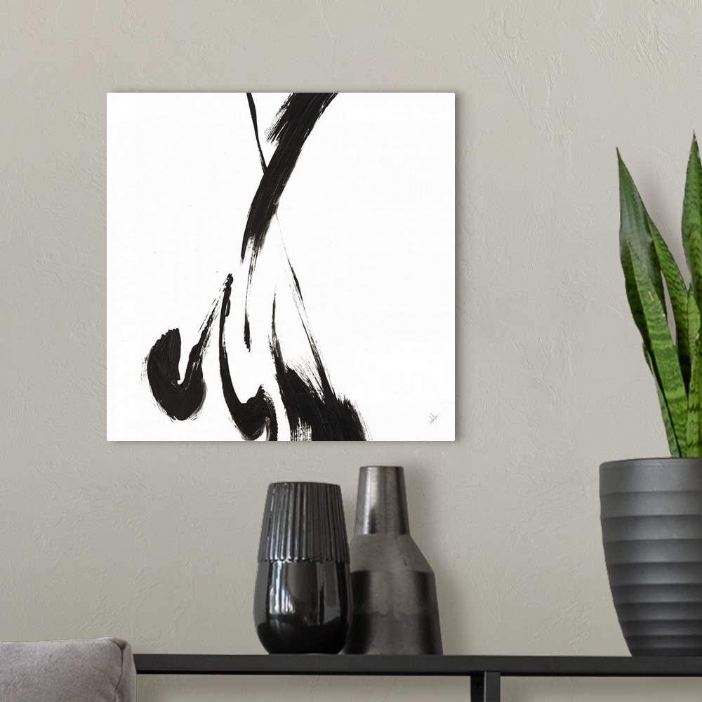 A modern room featuring Contemporary abstract art work of a few large brush strokes of black paint against white.