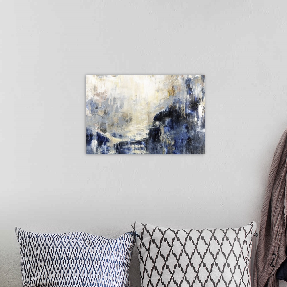 A bohemian room featuring An abstract painting of cool colors of blue and gold.