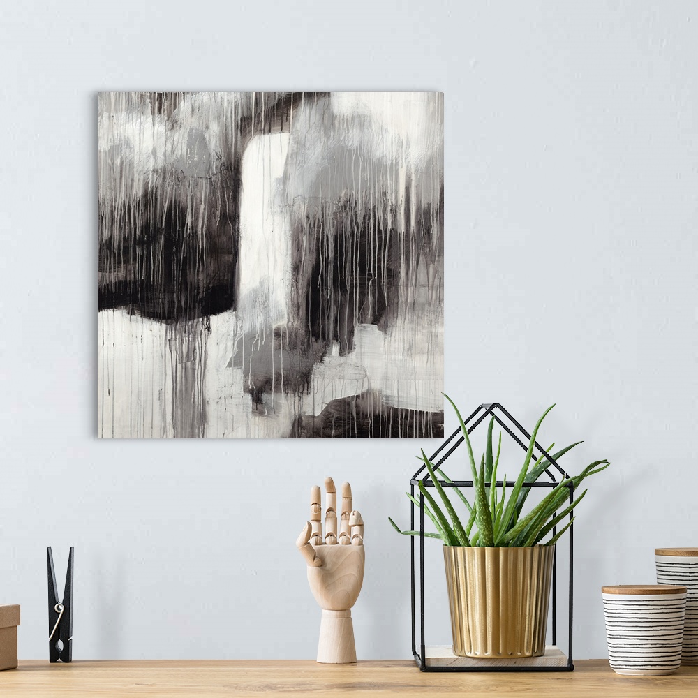 A bohemian room featuring Contemporary abstract painting in contrasting black and white shades with a dripping paint effect.