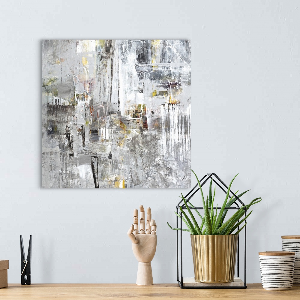 A bohemian room featuring Abstract painting of silver textured brush strokes with yellow accents.