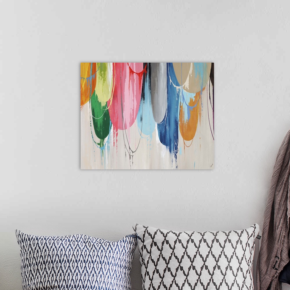 A bohemian room featuring Abstract painting of a cluster of brightly colored half circles that appear to have been pulled a...