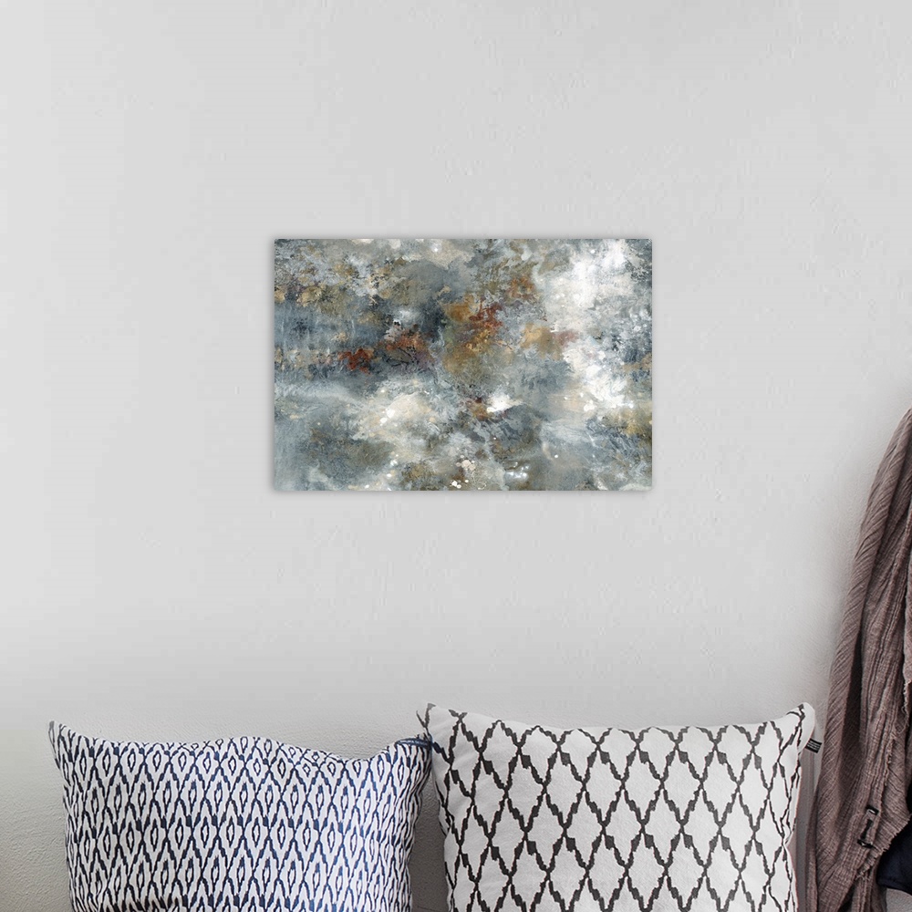 A bohemian room featuring Large abstract painting with blue, tan, white, gold, bronze, and silver hues.