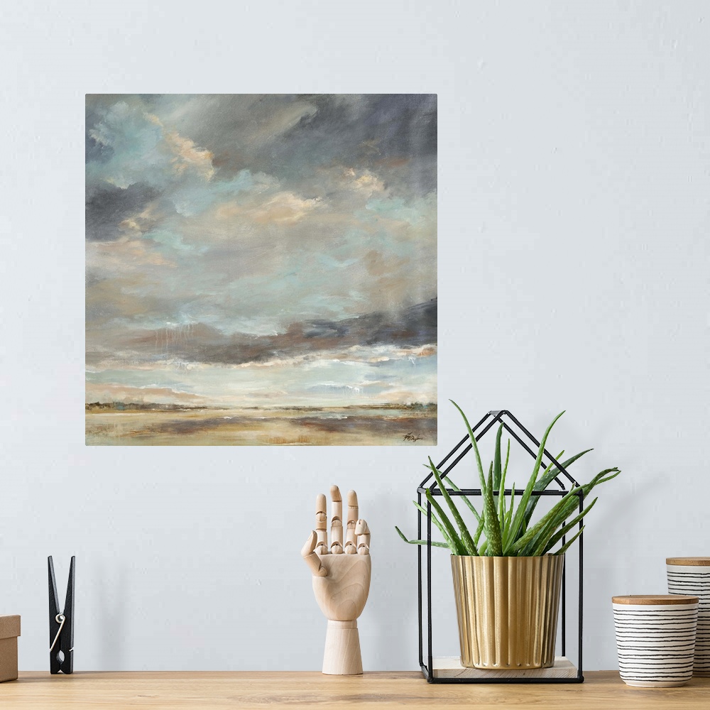 A bohemian room featuring Abstract painting of storm clouds moving into a thick sky of clouds over a vast, empty landscape.