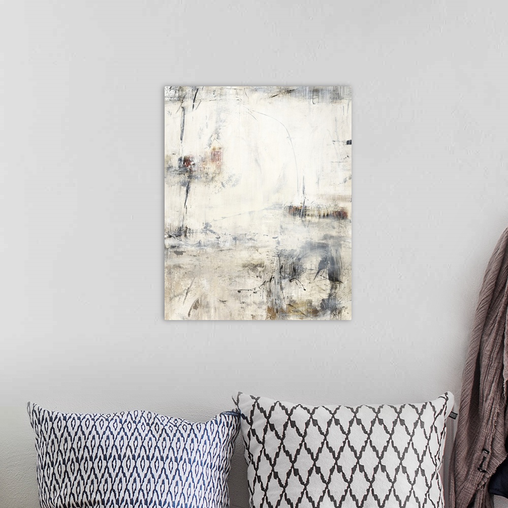 A bohemian room featuring A vertical painting of washed colors of gray and brown with dripped paint textures and swirled br...