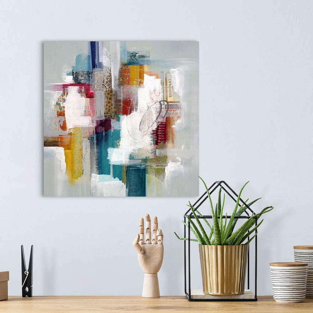 A bohemian room featuring Colorful abstract artwork with bright white spaces among red, blue, and yellow blocks.