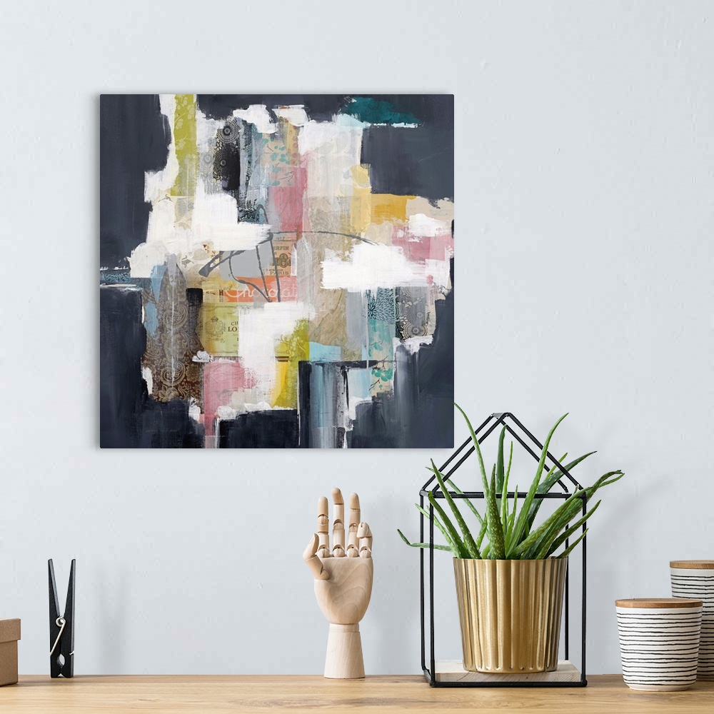 A bohemian room featuring Colorful abstract artwork with bright white spaces among pink, yellow, and navy blocks.