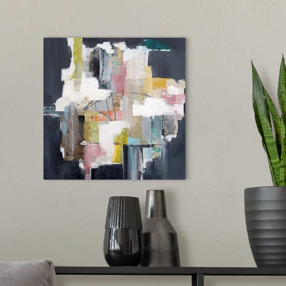 A modern room featuring Colorful abstract artwork with bright white spaces among pink, yellow, and navy blocks.