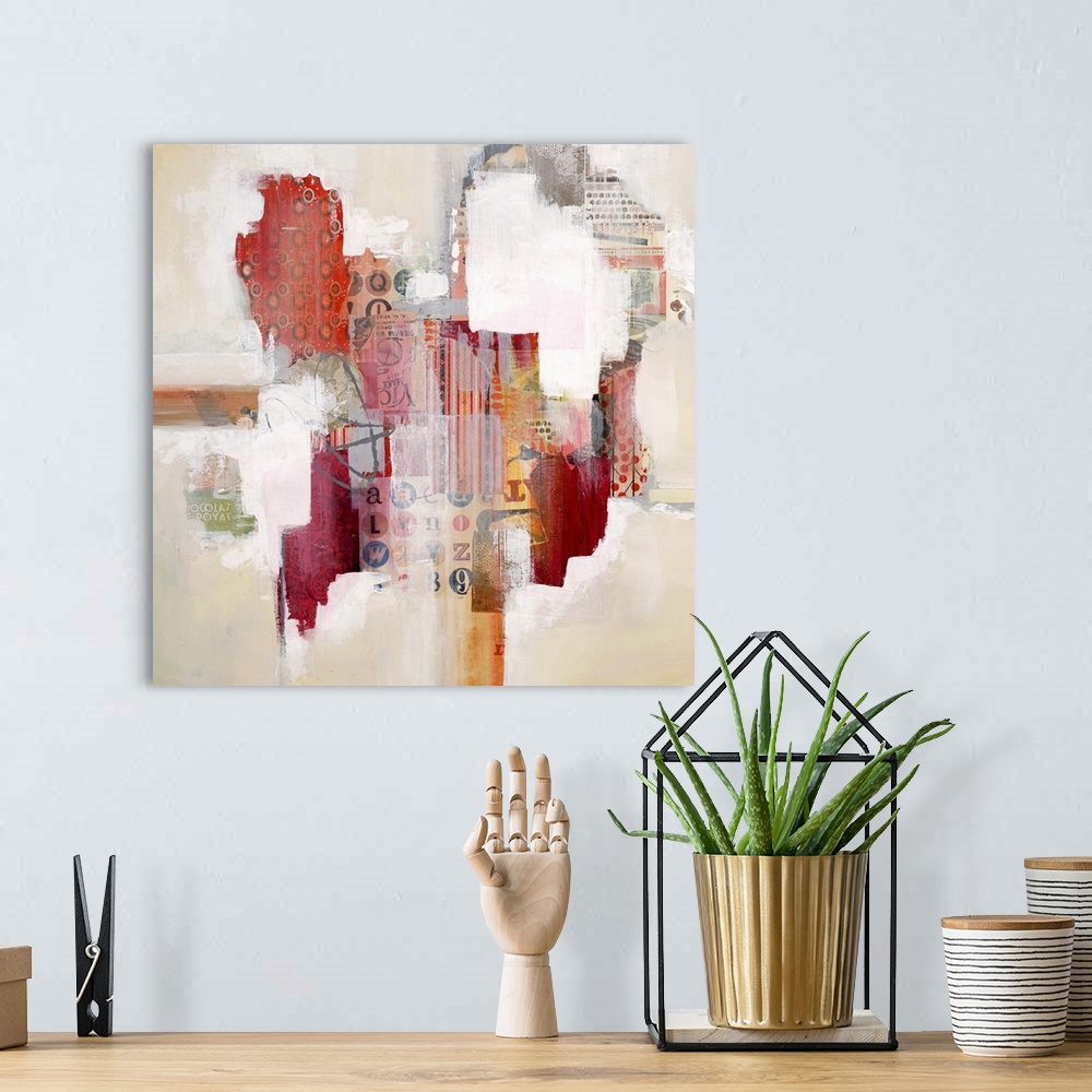 A bohemian room featuring Colorful abstract artwork with bright white spaces among red mixed media blocks.