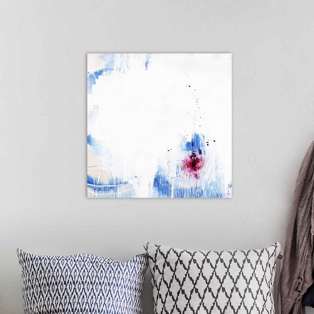 A bohemian room featuring A contemporary abstract painting of a vibrant blue and red against a white background.