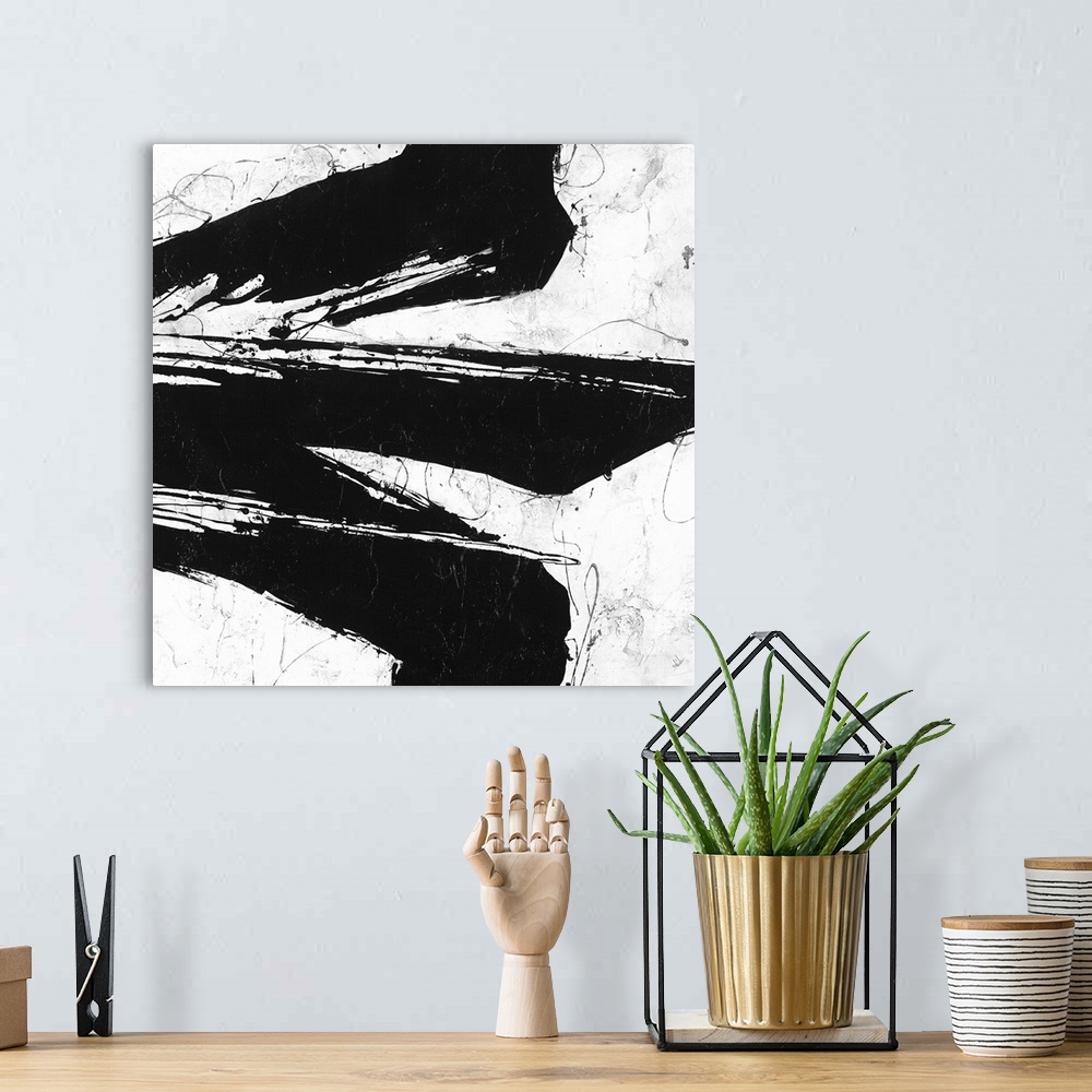 A bohemian room featuring Black and white abstract painting of black strokes of paint in wandering directions.