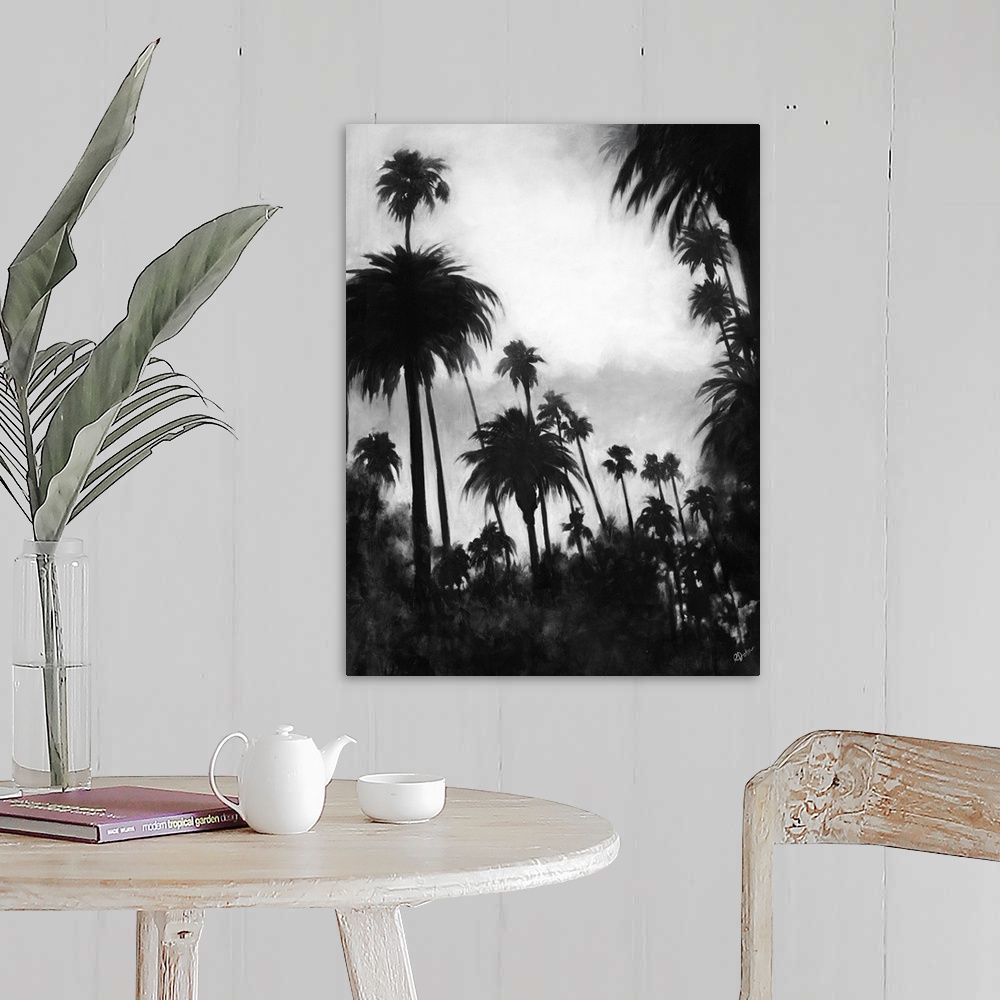 A farmhouse room featuring A black and white contemporary painting of a tree line of palm trees against of cloudy sky.
