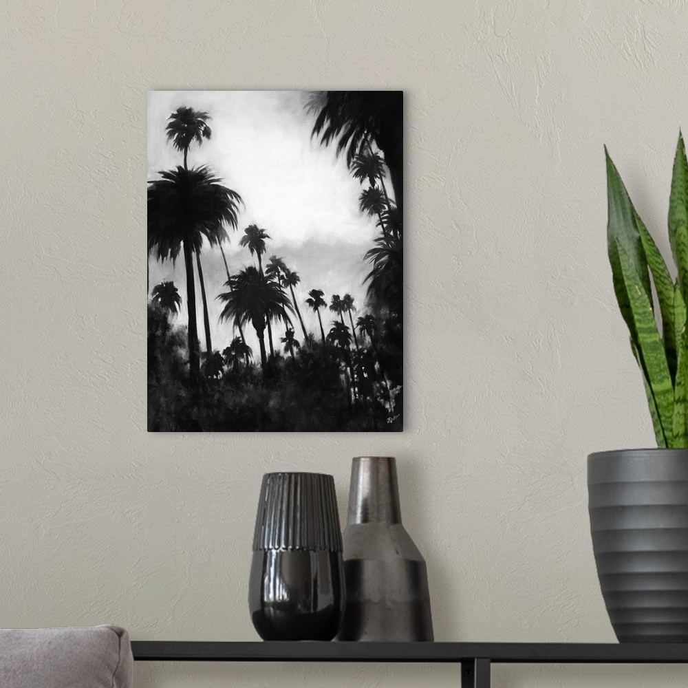 A modern room featuring A black and white contemporary painting of a tree line of palm trees against of cloudy sky.
