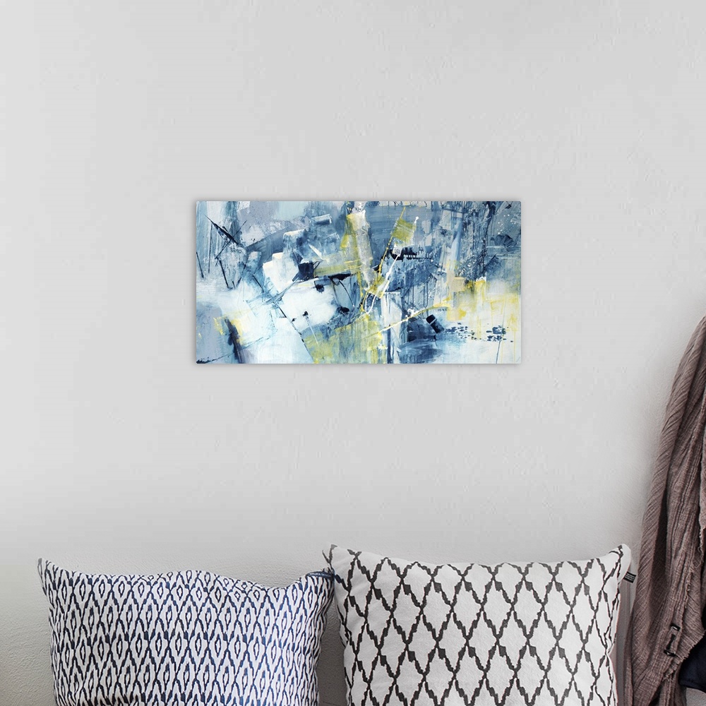 A bohemian room featuring Large abstract painting of textured blue brush strokes with yellow accents.