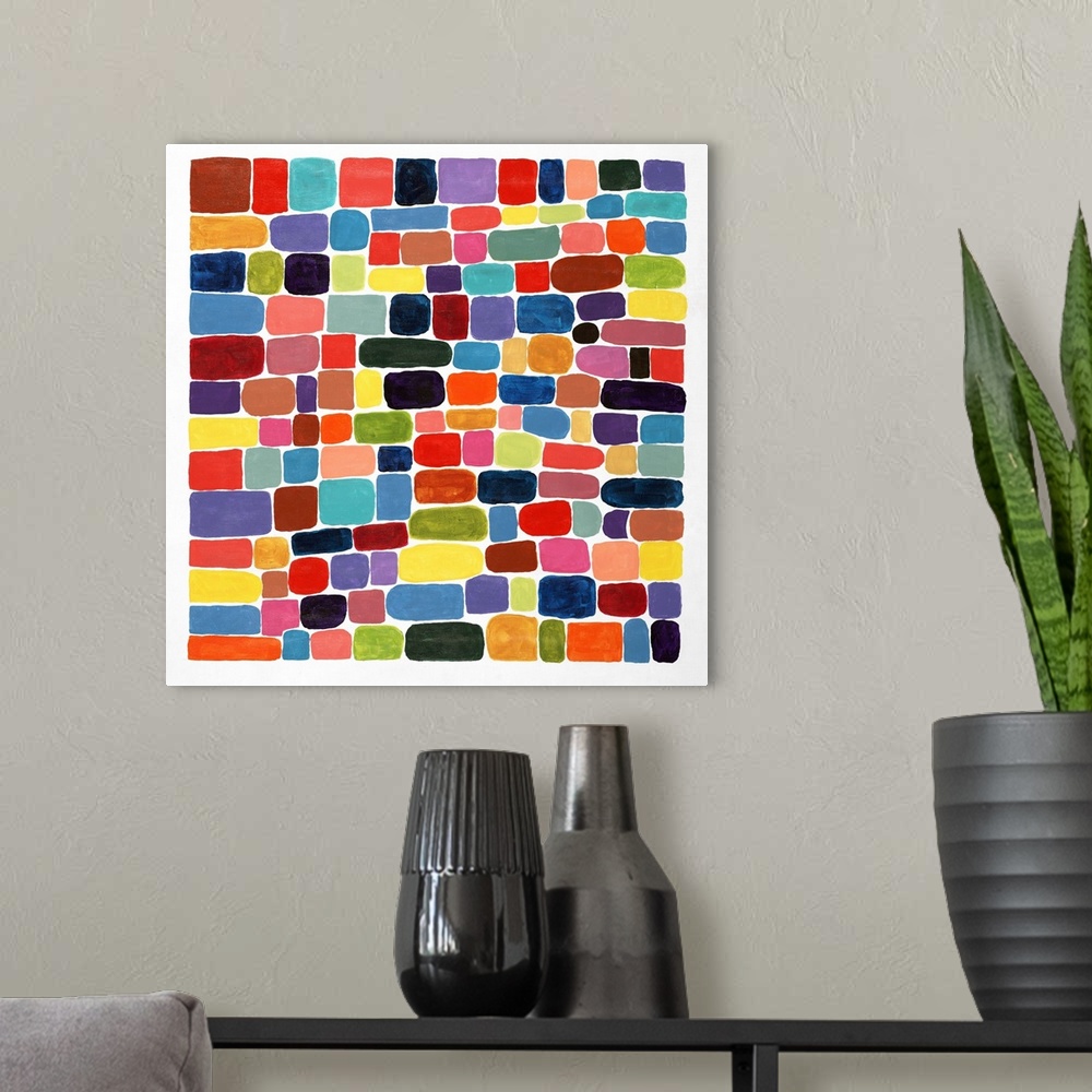 A modern room featuring Contemporary abstract painting of brightly colored shapes making a mosaic.