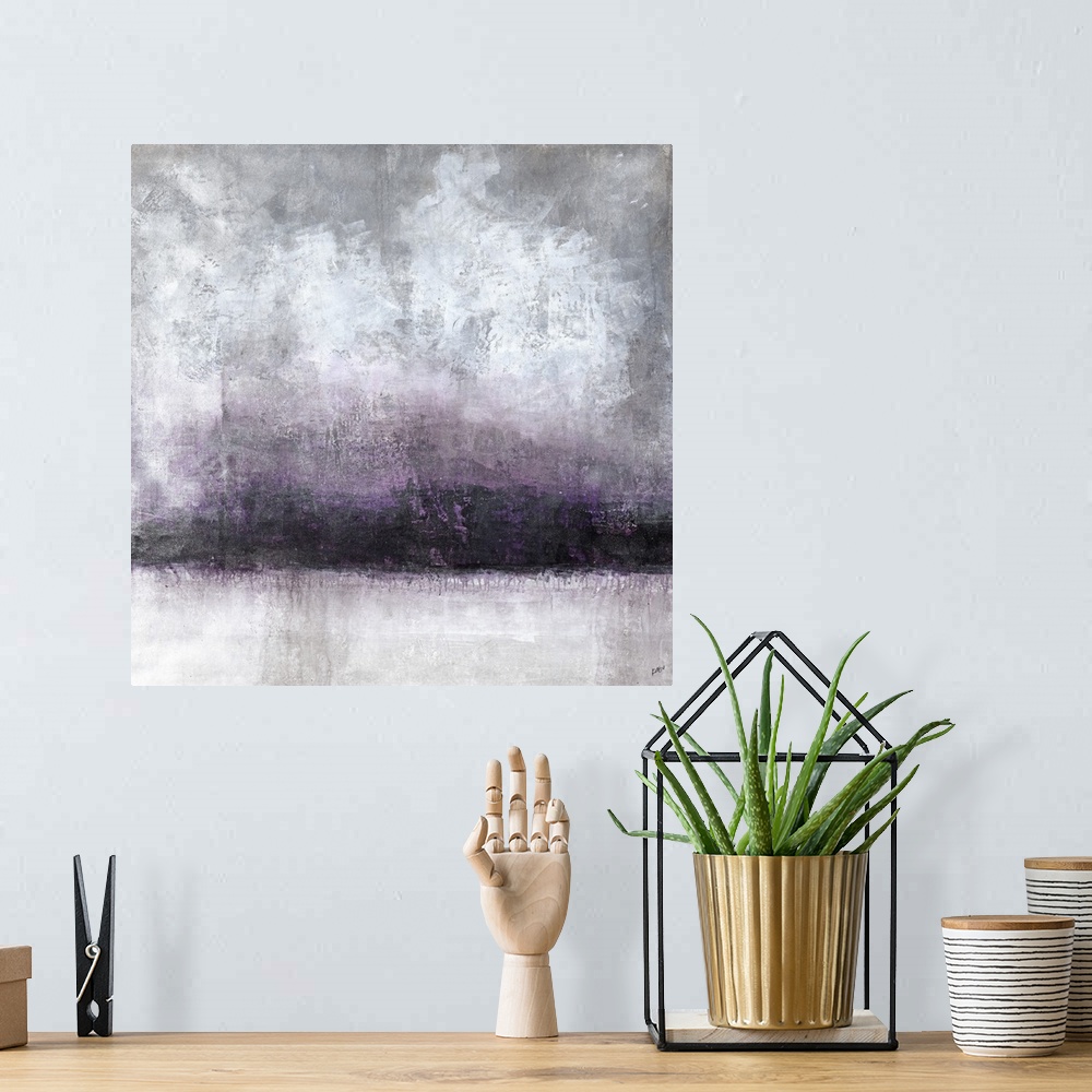 A bohemian room featuring A moody abstract landscape in shades of gray and purple.